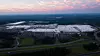Aerial view of the large Mercedes-Benz car plant in Alabama at sunset.