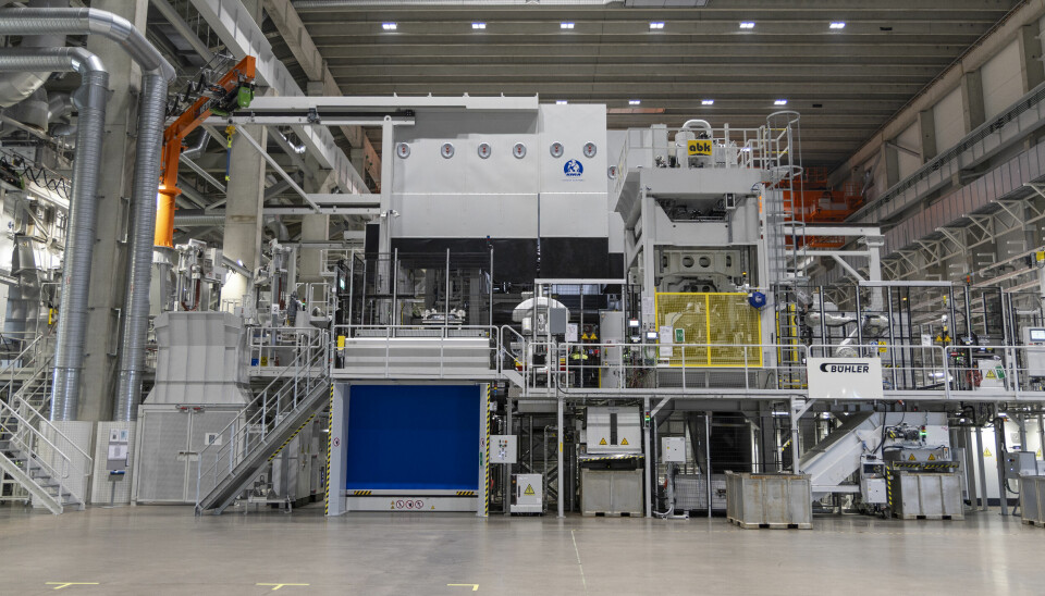 Large industrial aluminium casting machine inside Volvo factory hall.