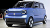 A blue Suzuki compact electric car shown front on in an indoor display area.
