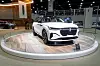 White Lincoln Nautilus SUV displayed on a circular platform at an auto show.