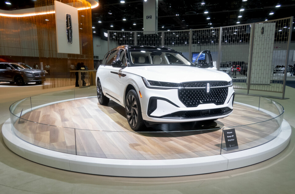 White Lincoln Nautilus SUV displayed on a circular platform at an auto show.