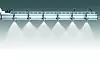 A row of mounted spray nozzles producing white mist in a factory-like setting.