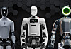 Three humanoid robots stand in a row against a dark hexagonal background.