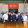 A group of people stand in a factory entrance beneath red Gotion signage.