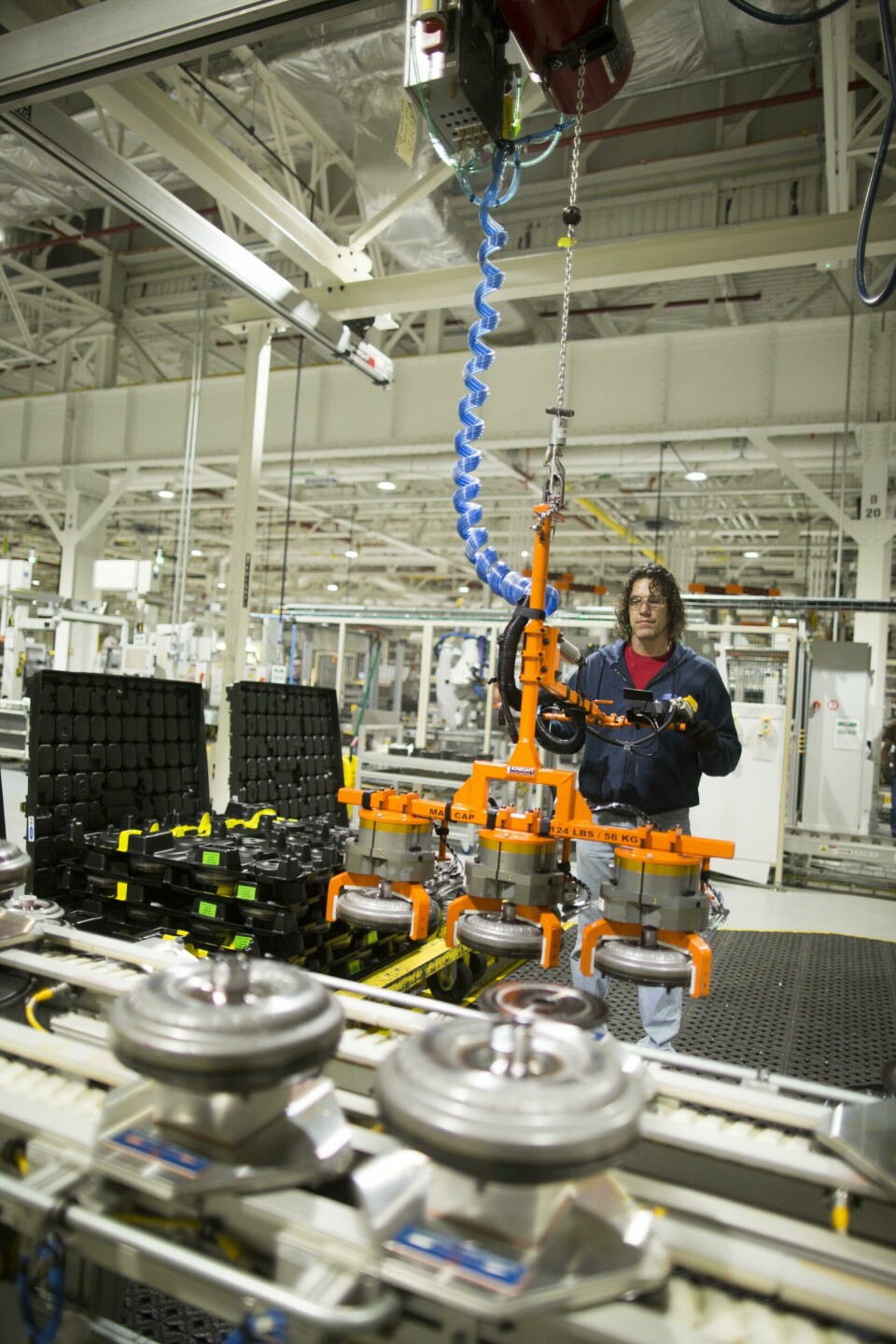 Torque converter assembly is a difficult task requiring the precise handling of heavy, awkward, sharp-edged components Transmission assembly at Ford Livonia
