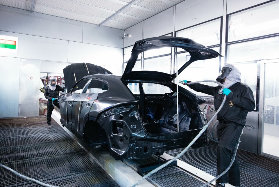 There are human workers spraying the bodies in the paintshop as well as robots Lamborghini paintshop humans