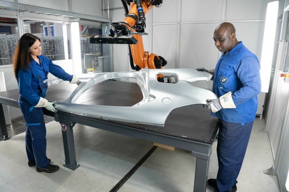 BMW workers inspect a car body panel. The company has been negotiating the supply of steel produced with less carbon-intensive methods from around 2026. P90487847-lowRes