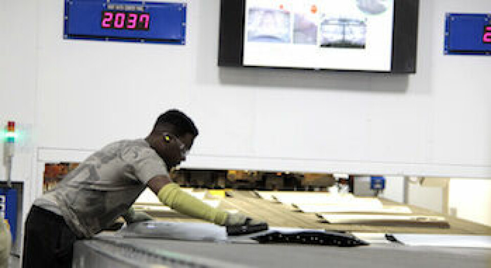 The upward curve of servo A quality check is performed on a freshly stamped door at FCA’s Warren Stamping Plant, Michigan