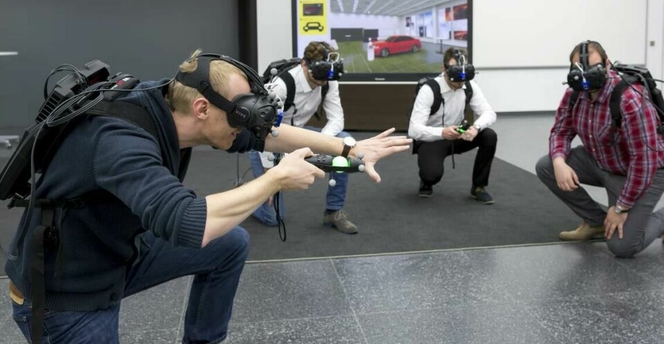 Martin Rademacher (left) and his colleagues from Audi’s planning are testing the Virtual Reality Holodeck to assess the design of a new vehicle model. Audi Martin Rademacher testing VR Holodeck